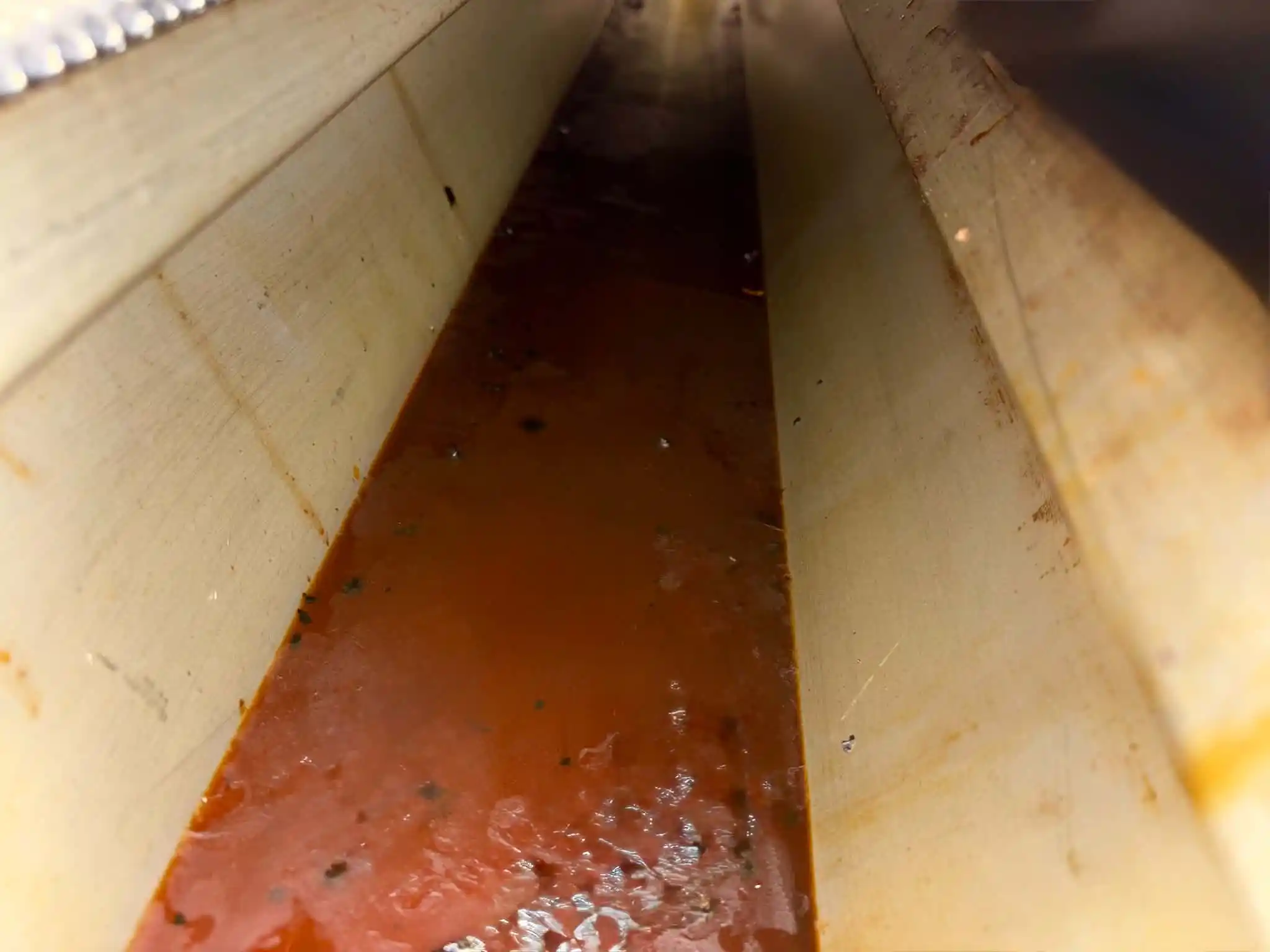 Grease pooling in canopy channel before cleaning